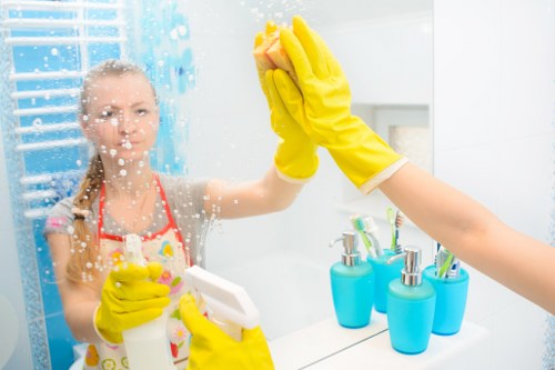 Cleaners in W4 carrying out deep cleaning services in a kitchen and bathroom