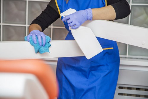Local office cleaners vacuuming and dusting a modern office in W4